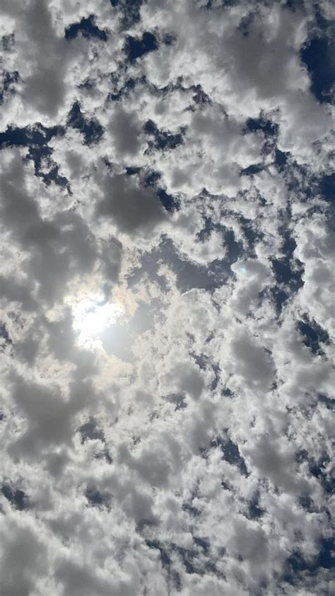 The Sun Is Shining Through Some Clouds In The Sky