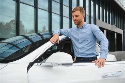 Premium Photo Handsome Young Businessman Standing Near His Car Outdoors