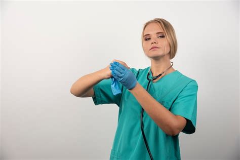 Free Photo Woman Doctor In Uniform Taking Off Latex Gloves