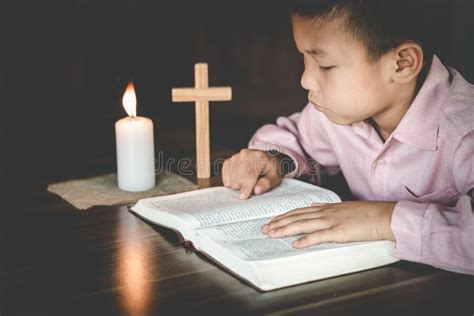 Religious Christian Child Praying Over Bible Indoors Religious