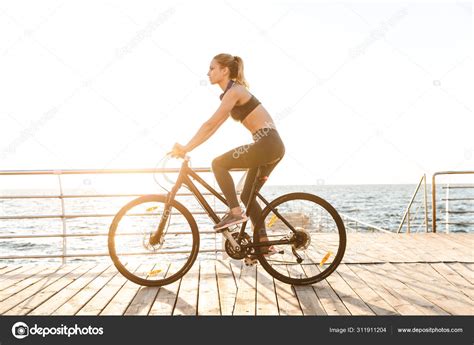 Beautiful young fitness woman cyclist wearing Stock Photo by ©Vadymvdrobot 311911204