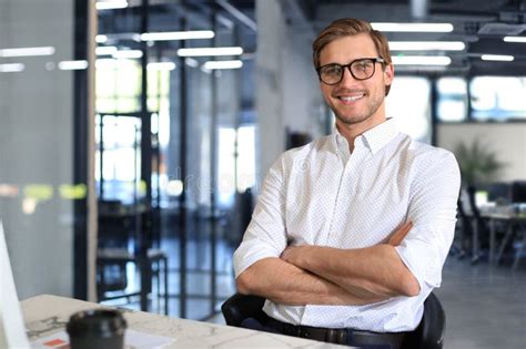 Portrait of Young Man Sitting at His Desk in the Office. Stock Photo ...