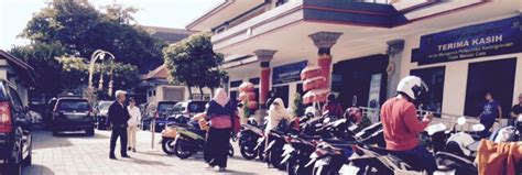 Motorcycles Parked On The Sidewalk In Front Of A Building With People