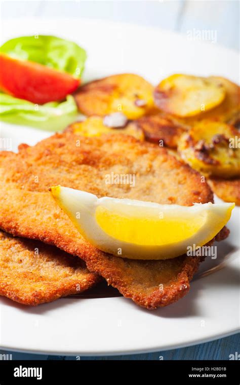 wiener schnitzel with roasted potatoes Stock Photo - Alamy