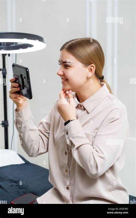 Makeup Artist Applies Eyebrow Tint For The Permanent Makeup Of A Young