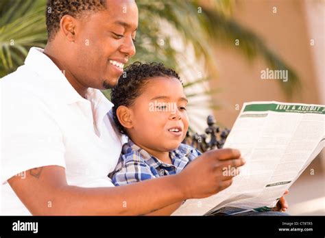 Happy African American Father And Mixed Race Son Having Fun Reading