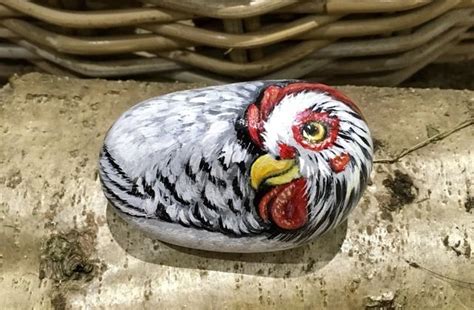 A Painted Chicken Sitting On Top Of A Rock