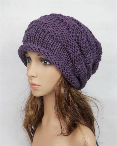 A Mannequin Head Wearing A Purple Knitted Hat