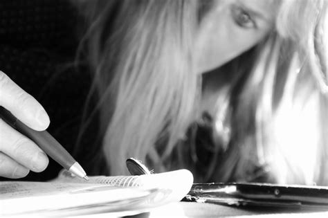 Premium Photo Close Up Of Woman Writing In Book