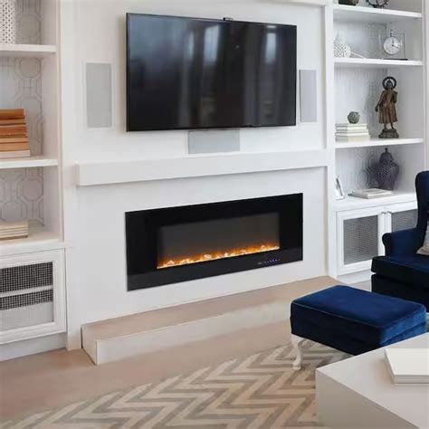 A Living Room With A Large Television Mounted On The Wall And A Fire