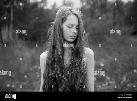 Caucasian Girl Standing In Field With Fuzz In Hair Stock Photo Alamy