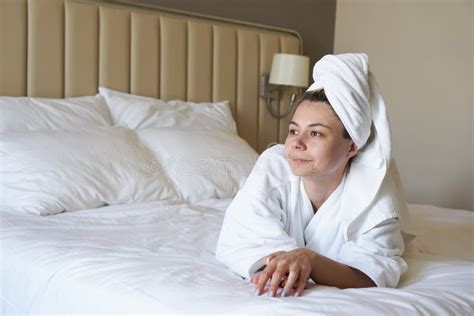 Happy Woman Resting Lying On The Bed After Showering At Home Or In