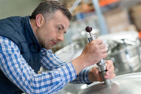 Man Screwing Bolt On Vat Stock Image Colourbox