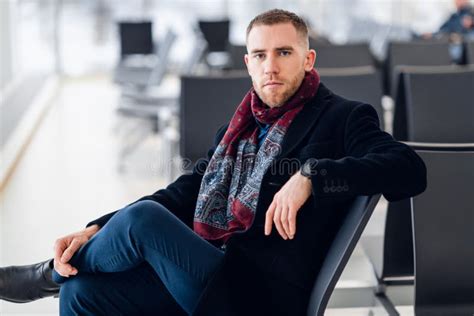 Businessman Sitting At Airport Waiting Lounge And Waiting For Flight