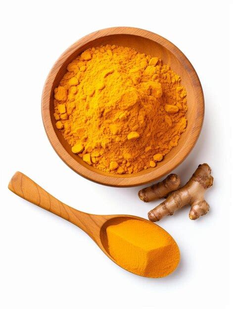 Premium Photo A Bowl Of Tumeric And A Wooden Spoon