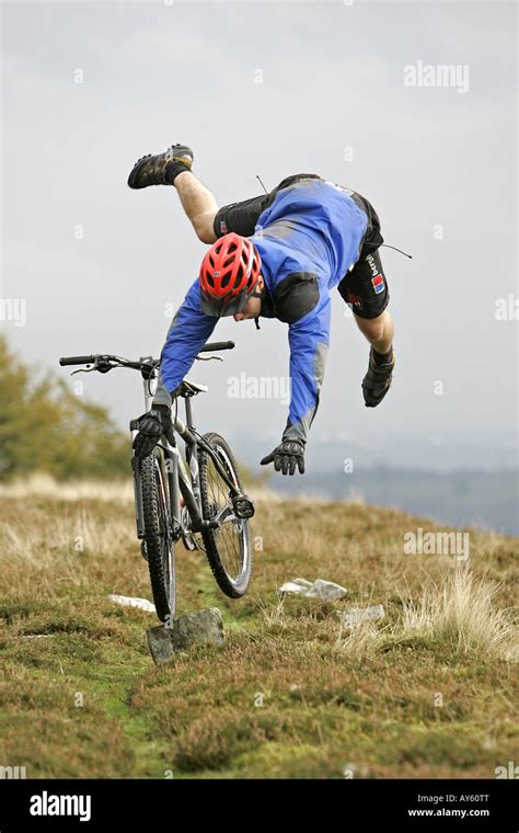 A mountain biker crashing with his mountain bike Stock Photo - Alamy