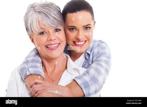 Happy Mature Mother And Adult Daughter Hugging On White Background