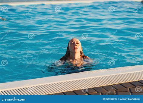 A Young Woman Emerging From The Pool Rest And Entertainment In The