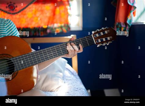 Woman Holding A Guitar In Her Hand Stock Photo Alamy