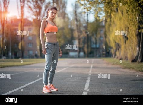 Attractive Brunette Woman Warm Up And Stretching In Park At Sunshine Stock Photo Alamy