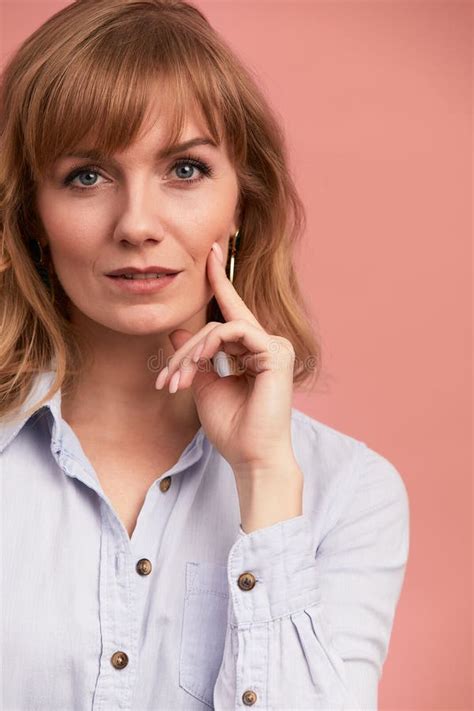 Portrait Of A Happy Smiling Mature Woman With Hand On Chin Looking At