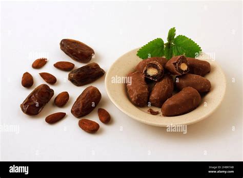 Dates with almond. Covered with milk chocolate Stock Photo - Alamy