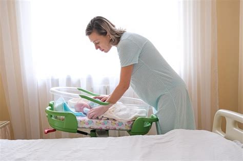 Premium Photo Newborn Baby Sleeping In Hospital Bassinet With Mom