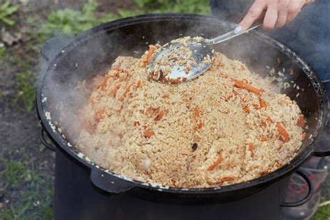 Premium Photo Cooking Food Or Pilaf In A Cauldron On Fire Cooking In