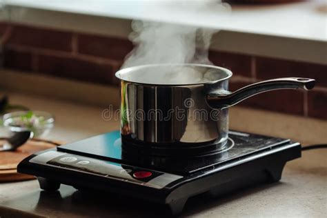 Saucepan With Boiling Water On The Electric Kitchen Stove Stock Photo