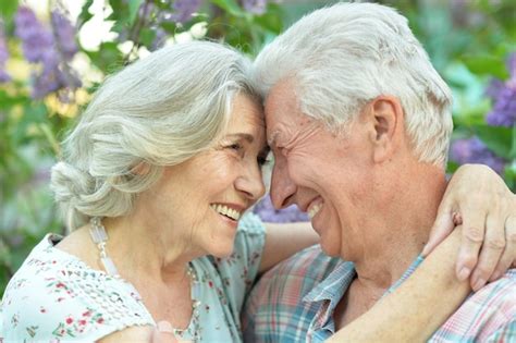 Premium Photo Beautiful Senior Couple Hugging On A Lilac Background