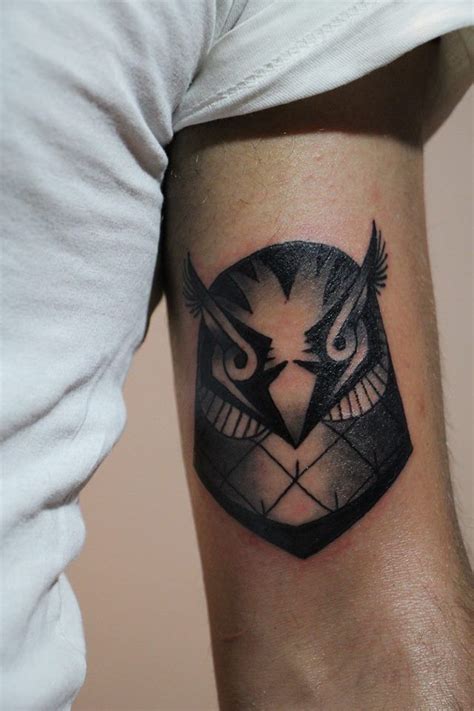 An Owl Tattoo On The Right Arm And Shoulder Is Shown In Black And Grey