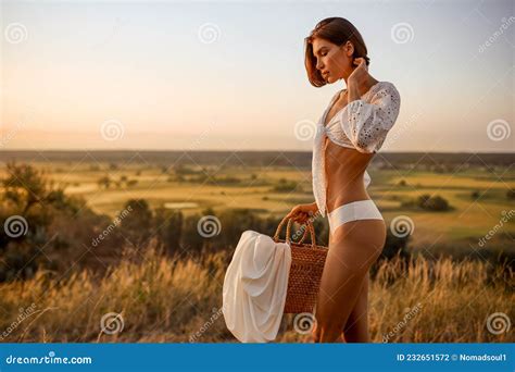 Woman In White Lingerie Holds Basket In The Field Stock Photo Image