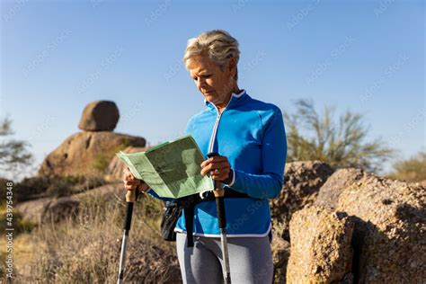 Senior Citizen Hiking In Arizona Desert And Reading Trail Map Stock