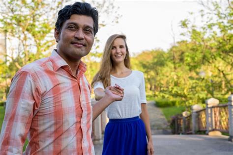 Feliz pareja multiétnica sonriendo con hombre indio Foto Premium