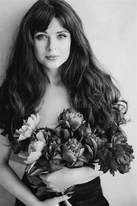 A Beautiful Woman Topless With Long Hair And A Bouquet Of Peonies