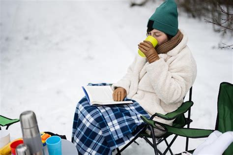 Premium Photo Woman Sit In Chair Read Book And Drink Tea In Winter