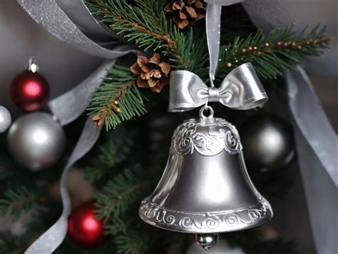 Premium AI Image | A Silver Bell Hanging On A Christmas Tree