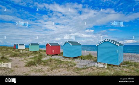 COLOURED BEACH HUTS ON THE BEACH AT FINDHORN MORAY SCOTLAND Stock Photo