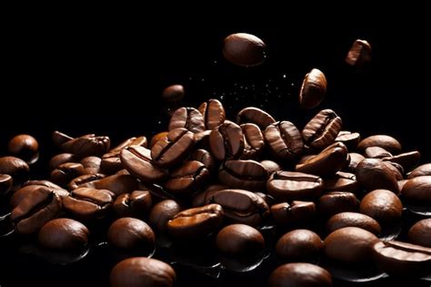 Premium Photo Roasted Falling Coffee Beans On Black Background