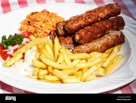 cevapcici with rice and chips fritters Stock Photo - Alamy