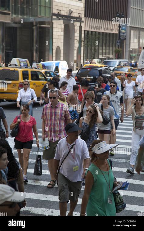 People Cross The Street At The Always Crowded Intersection Of 5th