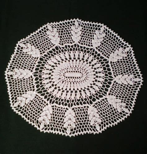 A White Doily On A Black Background