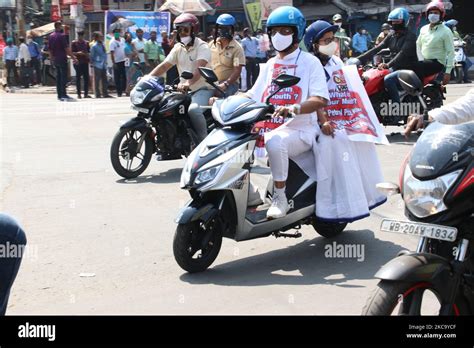 West Bengal Chief Minister Mamata Banerjee Hold Poster Protest And Ride Electric Scooter And