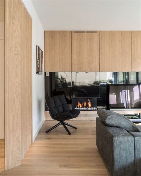 A Living Room With A Couch Chair And Fireplace In The Corner Next To It