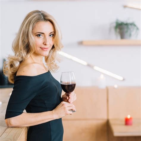 Free Photo Side View Of Lovely Woman Holding Glass Of Wine