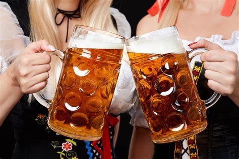 Young and Beautiful Bavarian Girls with Two Beer Mugs on Black ...