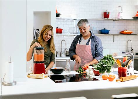 "Married Couple Cooking Together At Home" by Stocksy Contributor "Santi ...