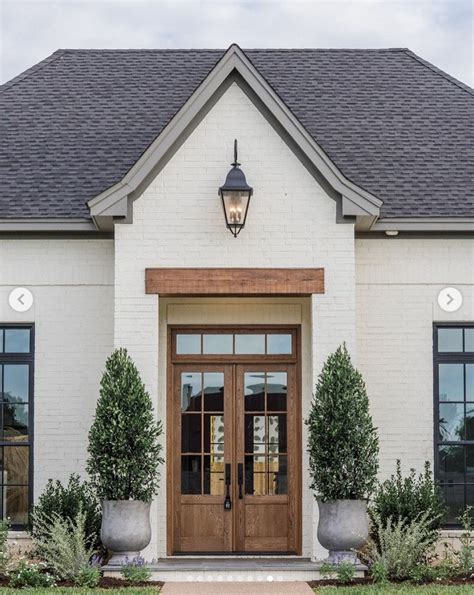 white brick house with wood shutters