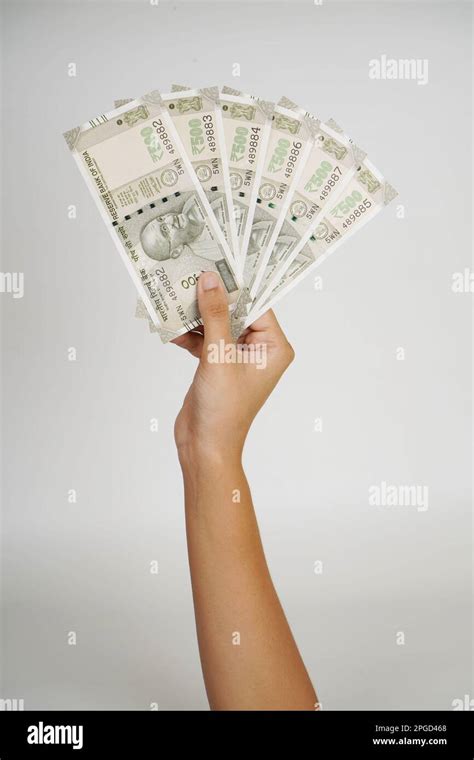 indian rupee note  hand  grey background stock photo alamy