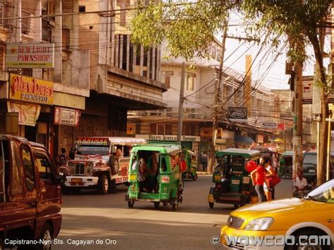 A Busy City Street Filled With Lots Of Vehicles And People Walking On